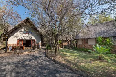 a large white building with a gambrel roof at Blyde River Canyon Lodge in Hoedspruit