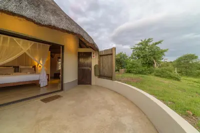 a room with a bed and a large window at Lengau Lodge in Grietjie Nature Reserve