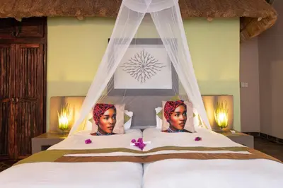 a bedroom with two women laying on top of a bed at Blyde River Wilderness Lodge in Hoedspruit