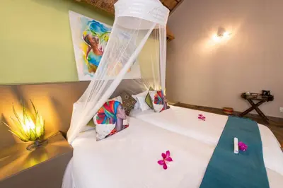 a bedroom with a white bed with a canopy at Blyde River Wilderness Lodge in Hoedspruit