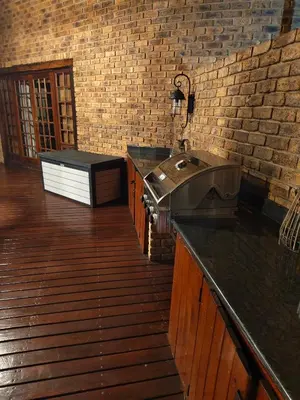 a kitchen with a sink and a brick wall at Tholo Private Game Lodge in Bela-Bela