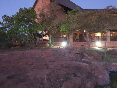 a home at night with lights in the yard at Tholo Private Game Lodge in Bela-Bela