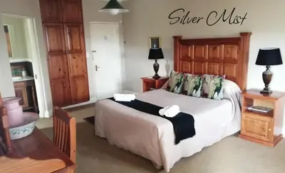 a bedroom with a bed with a sign on the wall at Silver Mist Guest House, Country Inn and Herberg in Kaapsehoop