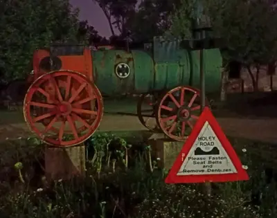 a sign with a train on it next to a warning sign at Silver Mist Guest House, Country Inn and Herberg in Kaapsehoop