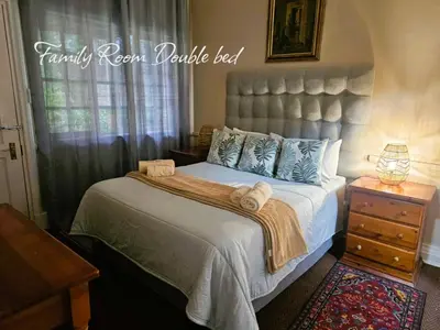 a bedroom with a large bed with towels on it at Silver Mist Guest House, Country Inn and Herberg in Kaapsehoop
