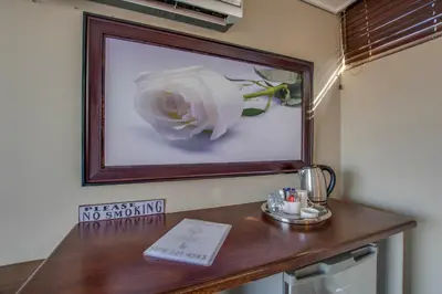 a picture of a white flower on a wall at Migdash Guesthouse in Hartbeespoort