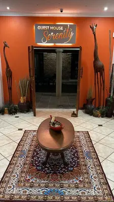 a guest house security room with a table and giraffe statues at Guesthouse Serenity in Hartbeespoort