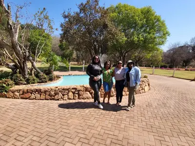 a group of people standing in front of a park at Guesthouse Serenity in Hartbeespoort