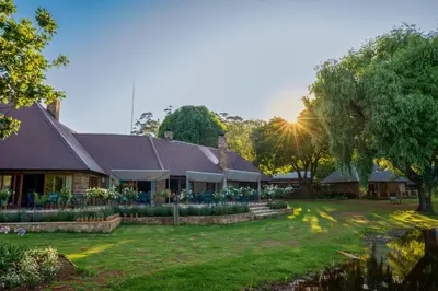 a house with a yard and a building at Walkersons Hotel & Spa in Dullstroom