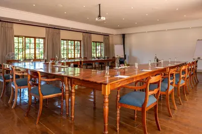 a large conference room with a large wooden table and chairs at Walkersons Hotel & Spa in Dullstroom