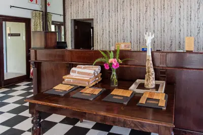 a wooden desk with a table with items on it at Perry's Bridge Hollow Boutique Hotel in Hazyview