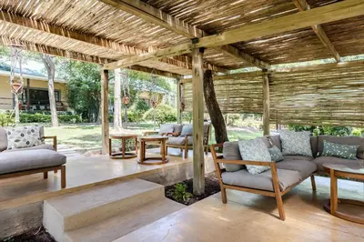 an outdoor living room with couches and tables at Perry's Bridge Hollow Boutique Hotel in Hazyview
