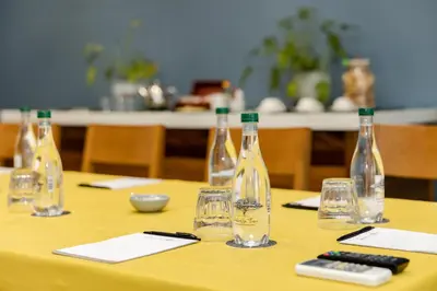 a table with bottles and glasses and a remote control at Perry's Bridge Hollow Boutique Hotel in Hazyview