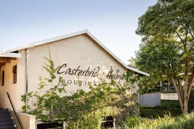 a building with writing on the side of it at Casterbridge Hollow Boutique Hotel in White River