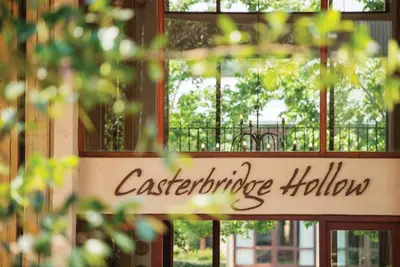 a sign for a cafegraduate hall in front of a window at Casterbridge Hollow Boutique Hotel in White River