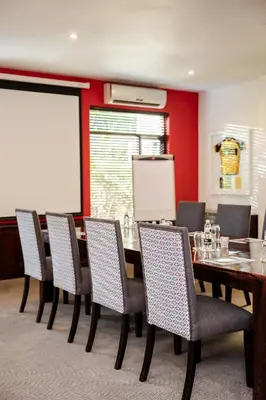 a conference room with a long table and chairs at Casterbridge Hollow Boutique Hotel in White River