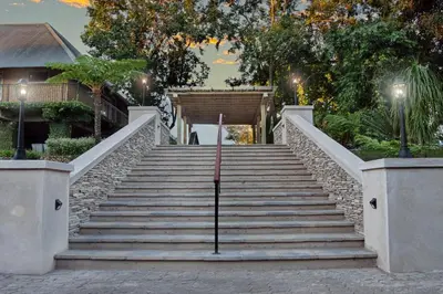 a set of stairs in front of a building with lights at Hippo Hollow Country Estate in Hazyview