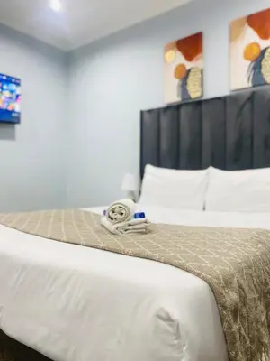 a close up of a bed in a hotel room at Airport Imperial Guest House in Kempton Park