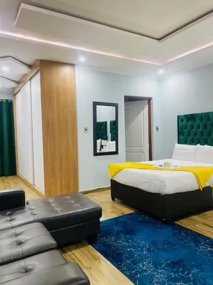 a bedroom with a large bed and a couch at Airport Imperial Guest House in Kempton Park