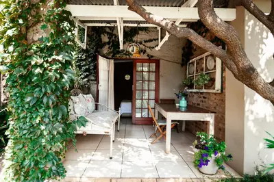a patio with a table and a tree at Town and Country Mpumalanga in Middelburg