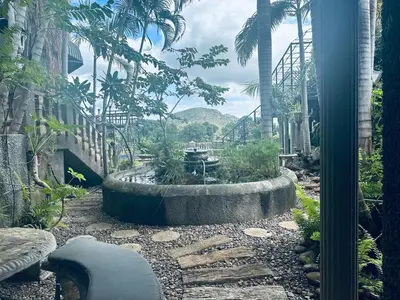 a garden with a fountain in the middle of a building at Belvedere-on-River in Malelane