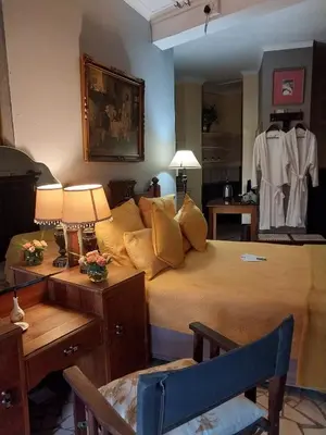 a bedroom with a bed and a mirror at Belvedere-on-River in Malelane