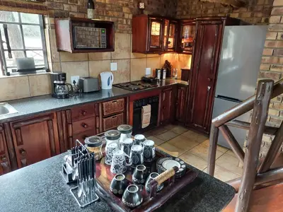 a kitchen with a table with pots and pans on it at Khumbula iAfrica 1 in Marloth Park