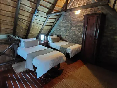 a room with two beds in a attic at Khumbula iAfrica 1 in Marloth Park