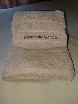 a towel with the words kumbucha kirribilli kirribilli at Khumbula iAfrica 1 in Marloth Park