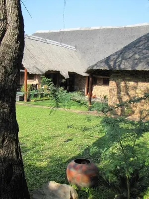 a large vase sitting in front of a building at SERENITY Du Bois Lodge in Marloth Park