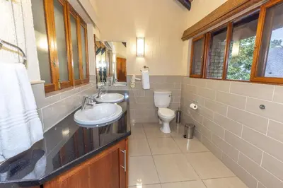 a bathroom with two sinks and a toilet at Legend Safaris 257B - in Kruger Park Lodge in Hazyview