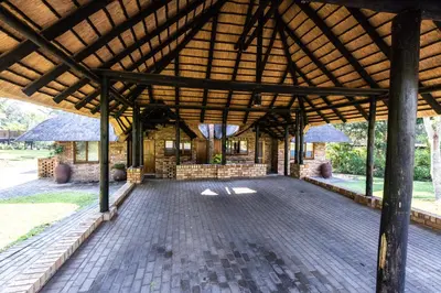 a pavilion with a brick floor and a wooden roof at Legend Safaris 257B - in Kruger Park Lodge in Hazyview