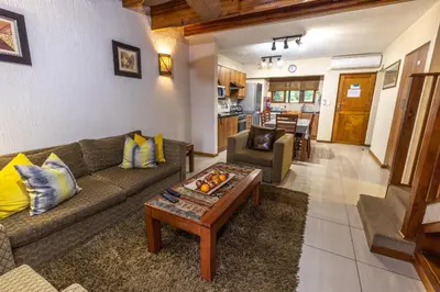 a living room with a couch and a table at Legend Safaris 257B - in Kruger Park Lodge in Hazyview