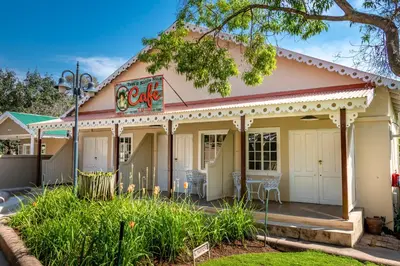 a building with a cafe on a street at Little Pilgrims Boutique Hotel in Hazyview