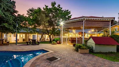 a backyard with a swimming pool and a building at Little Pilgrims Boutique Hotel in Hazyview