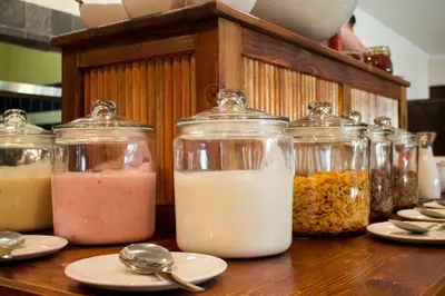 a table with jars filled with different types of food at Little Pilgrims Boutique Hotel in Hazyview