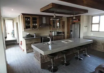 a kitchen with a large island in the middle of it at Feeskraal Lodge in Moheme