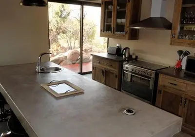 a kitchen with a counter with a cutting board on it at Feeskraal Lodge in Moheme