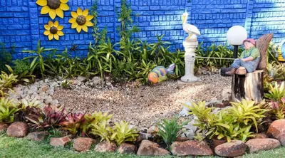 a garden with a gnome and a statue in a yard at La Frans Guesthouse in Pretoria
