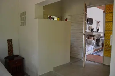 a room with a hallway with a door to a living room at Leopard Tree Retreat in Nelspruit