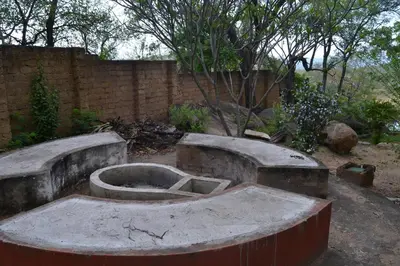 a garden with two concrete bowls and a brick wall at Leopard Tree Retreat in Nelspruit
