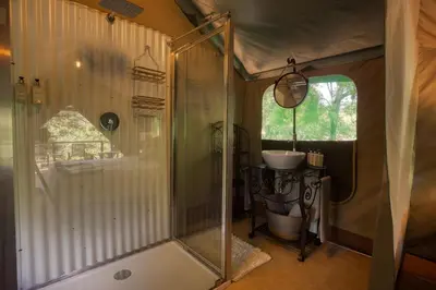 a bathroom with a shower and a sink at Camp Bethel in Hoedspruit