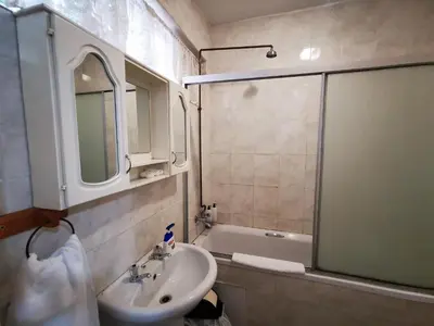a bathroom with a sink and a bath tub at Meintjieskop Self-Catering Accommodation in Pretoria