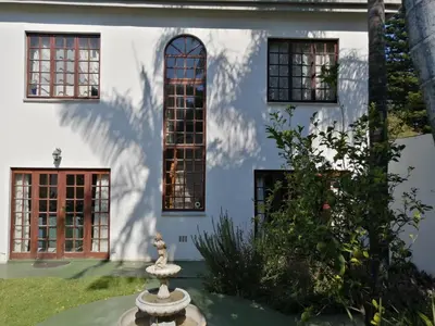a building with windows and a statue in front of it at Meintjieskop Self-Catering Accommodation in Pretoria