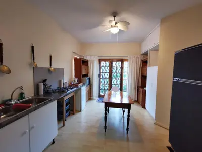 a kitchen with a table in the middle of it at Meintjieskop Self-Catering Accommodation in Pretoria