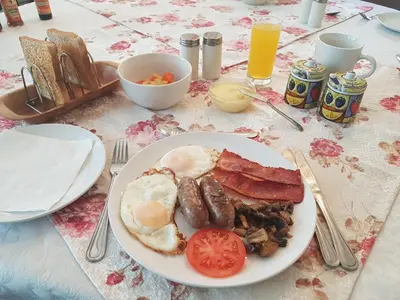a plate of breakfast food on a table at 360 Eastwoods Guesthouse in Pretoria