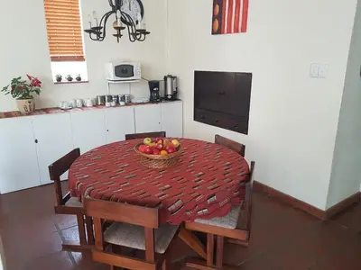 a kitchen with a table with a bowl of fruit on it at 360 Eastwoods Guesthouse in Pretoria