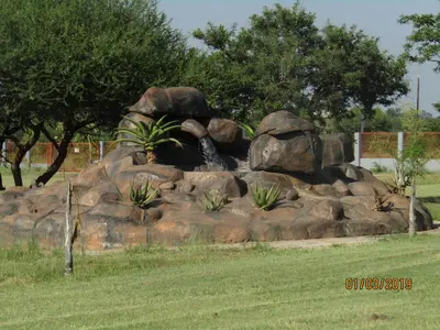 a pile of rocks with a water fountain at Vido Lodge and Conference Centre in Polokwane