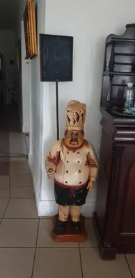 a statue of a chef standing next to a sign at Sherwood's Country House in Tzaneen