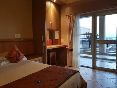 a bedroom with a bed and a sliding glass door at Bubez Guesthouse in Barberton